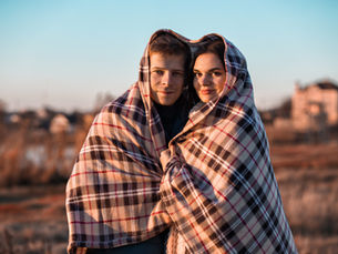 2 people wrapped up in a heart shaped blanket