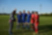 Coach and his football team on the field