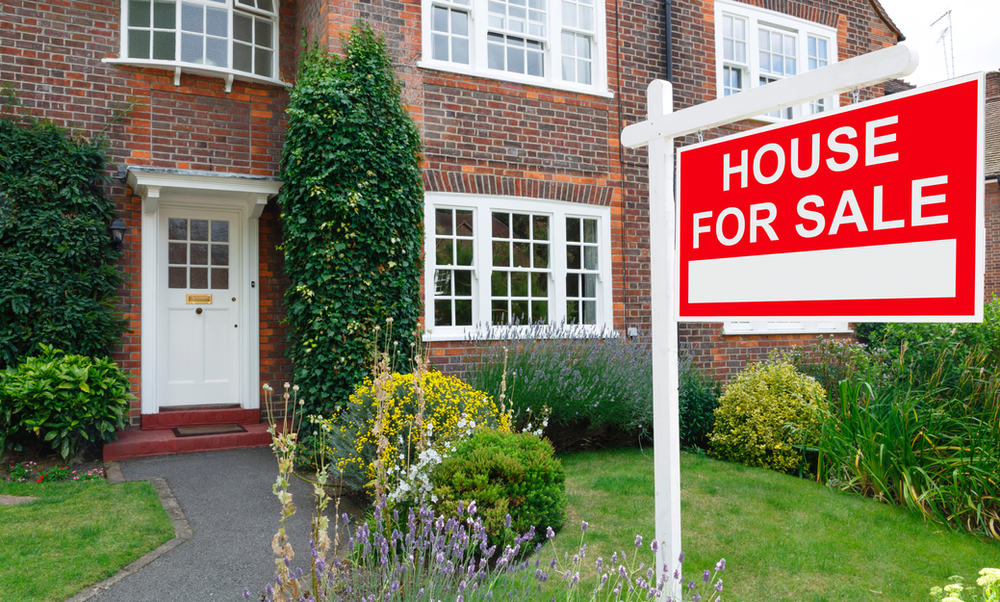 res for sale sign in front of brick house