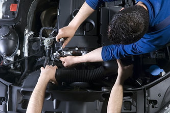 Auto mechanic team working on car's engine