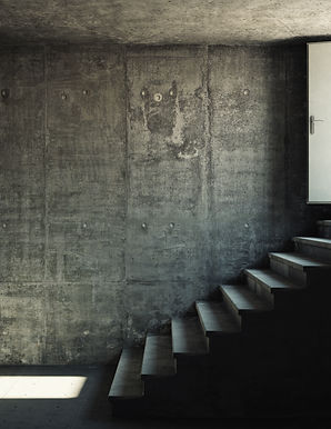 Interior room with concrete walls and stairs leading to the exit