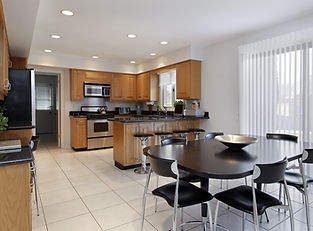 Kitchen in a home with tile flooring and white walls