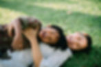 Mother and son lying on the grass.