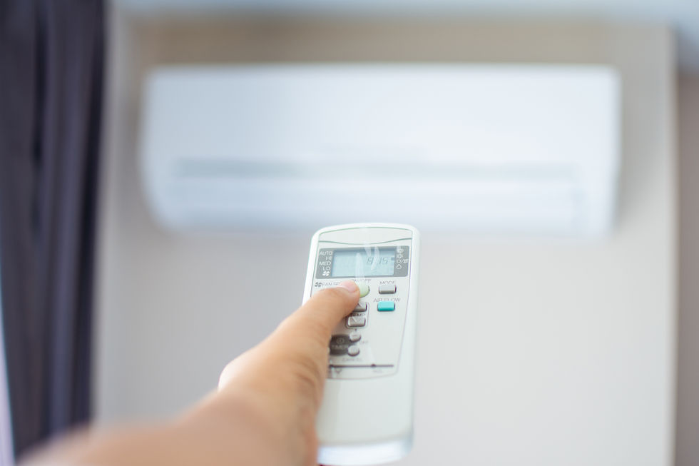 human hand press on remote control of Air Conditioner with hot weather