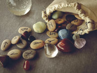 Aset of rune stones falling out of a hessian bag