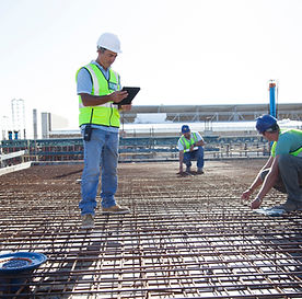 Construction workers arranging rebar at construction site