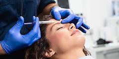 Woman receiving botox injections for forehead lines