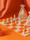 Orange and white chess board with chess pieces