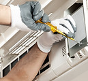 Air conditioner technician servicing indoor