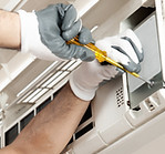 Air conditioner technician servicing indoor