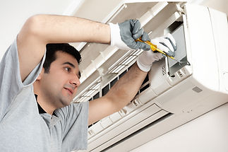 Air conditioning technician servicing an indoor unit
