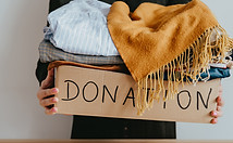 Woman holding a box of clothes for donation