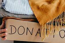 Woman holding a box of clothes for donation