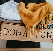 Woman holding a box of clothes for donation