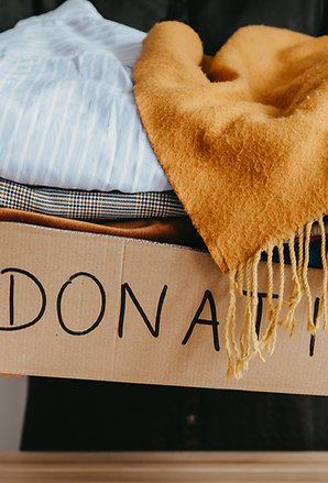 Woman holding a box of clothes for donation