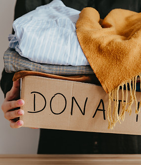 Woman holding a box of clothes for donation
