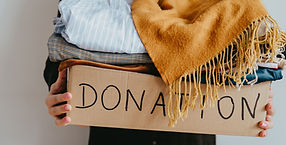 Woman holding a box of clothes for donation