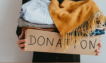 Woman holding a box of clothes for donation