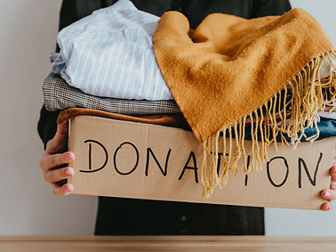Woman holding a box of clothes for donation