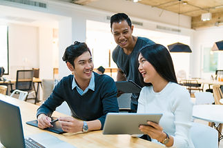A group of people talking with tablet PC in hand