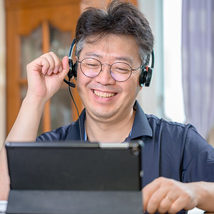 Smiling Person Talking through Headphones