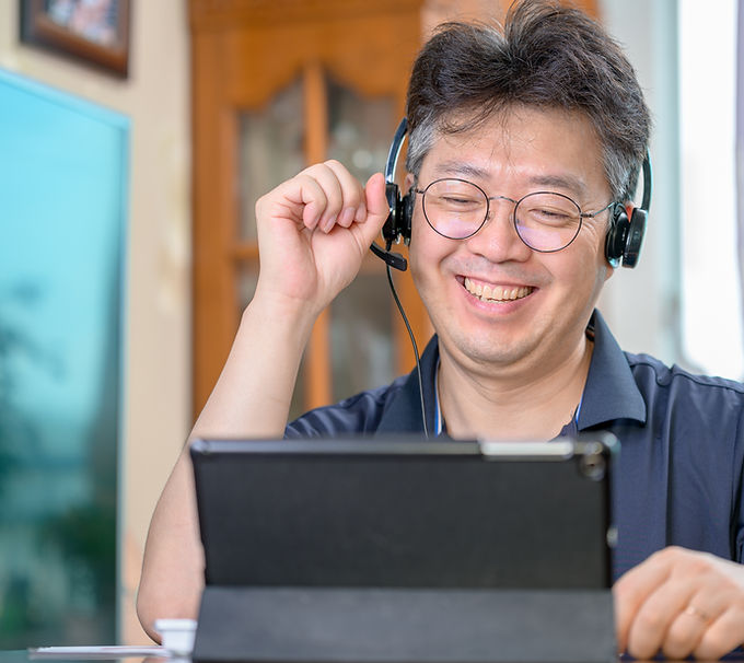 Smiling Person Talking through Headphones