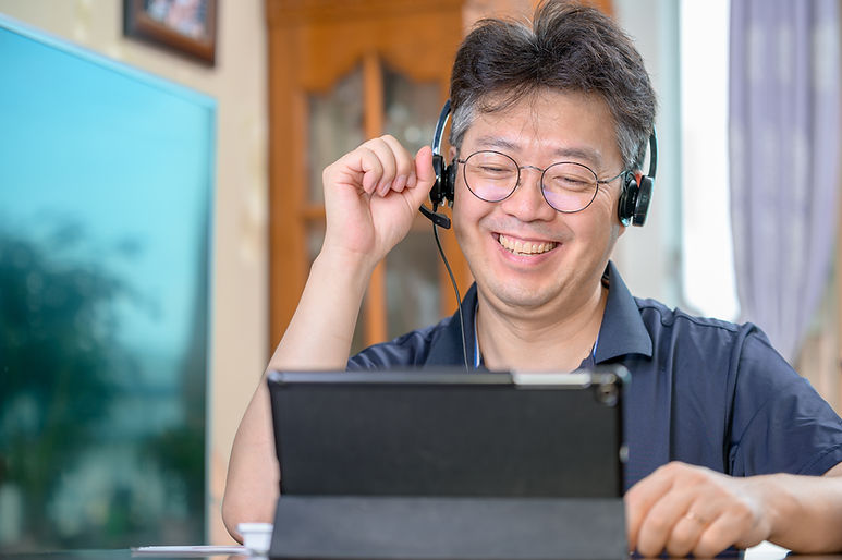 Smiling Person Talking through Headphones