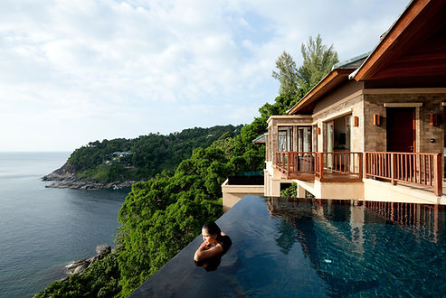 A girl in a pool on a hill on an island
