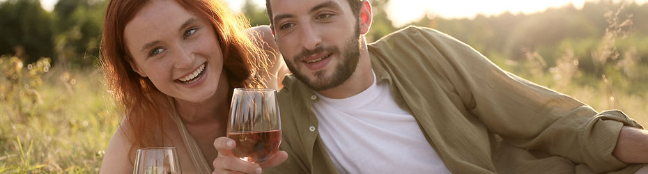 Couple sharing drinks while enjoying their picnic