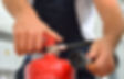A man checking a fire extinguisher for servicing