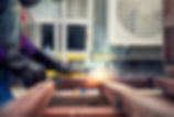 worker welding metal frame