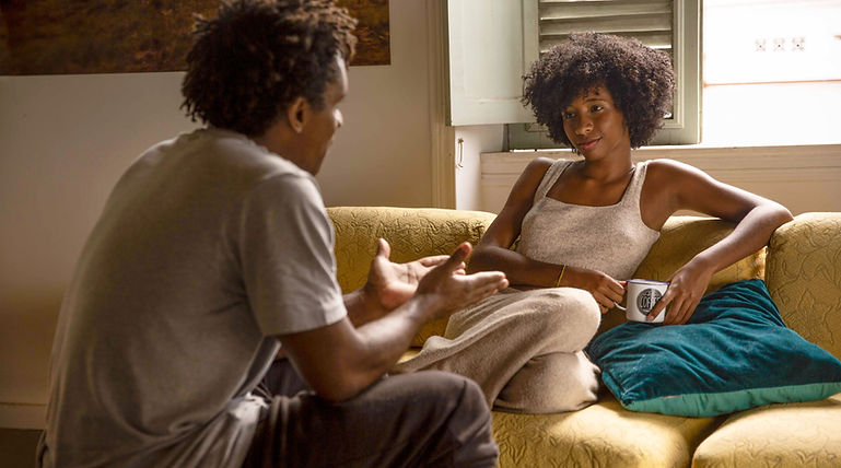 Couple conversing in their living room