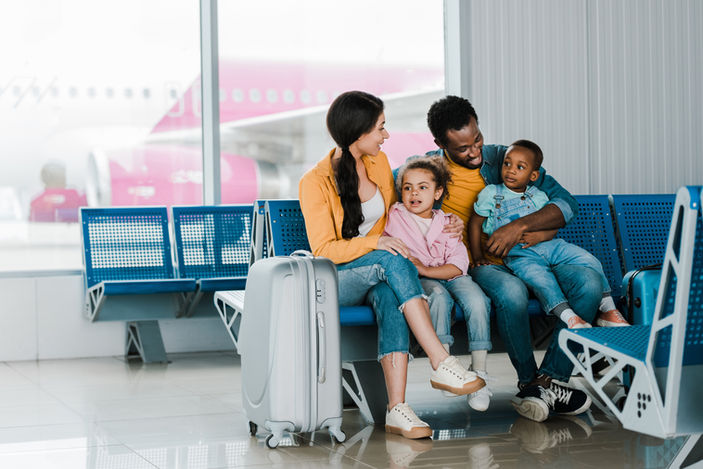 family at airport happy for their trip