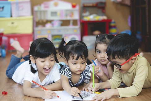 Children drawing together in creative preschool classroom