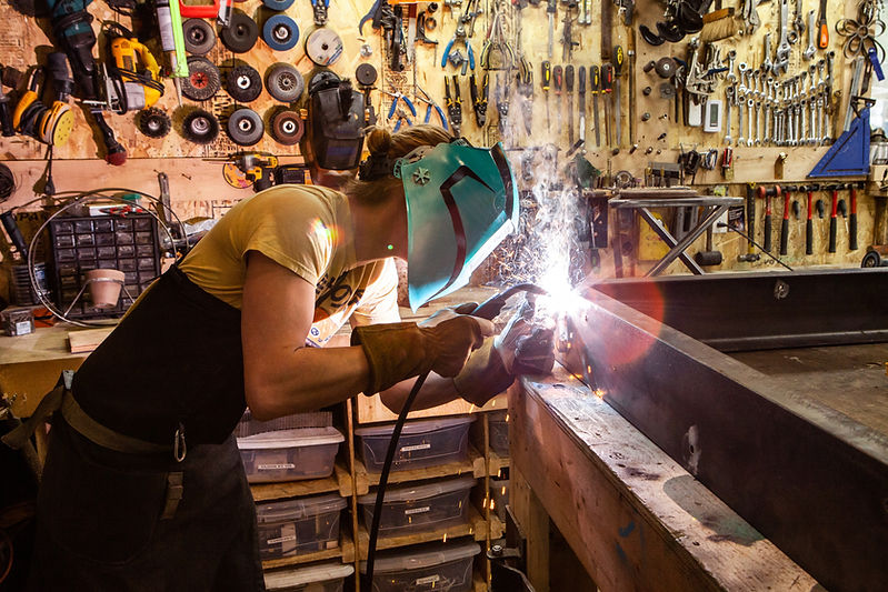 Metalworker using Welding Machine