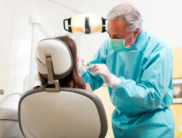 A dentist examining a patient using a explorer