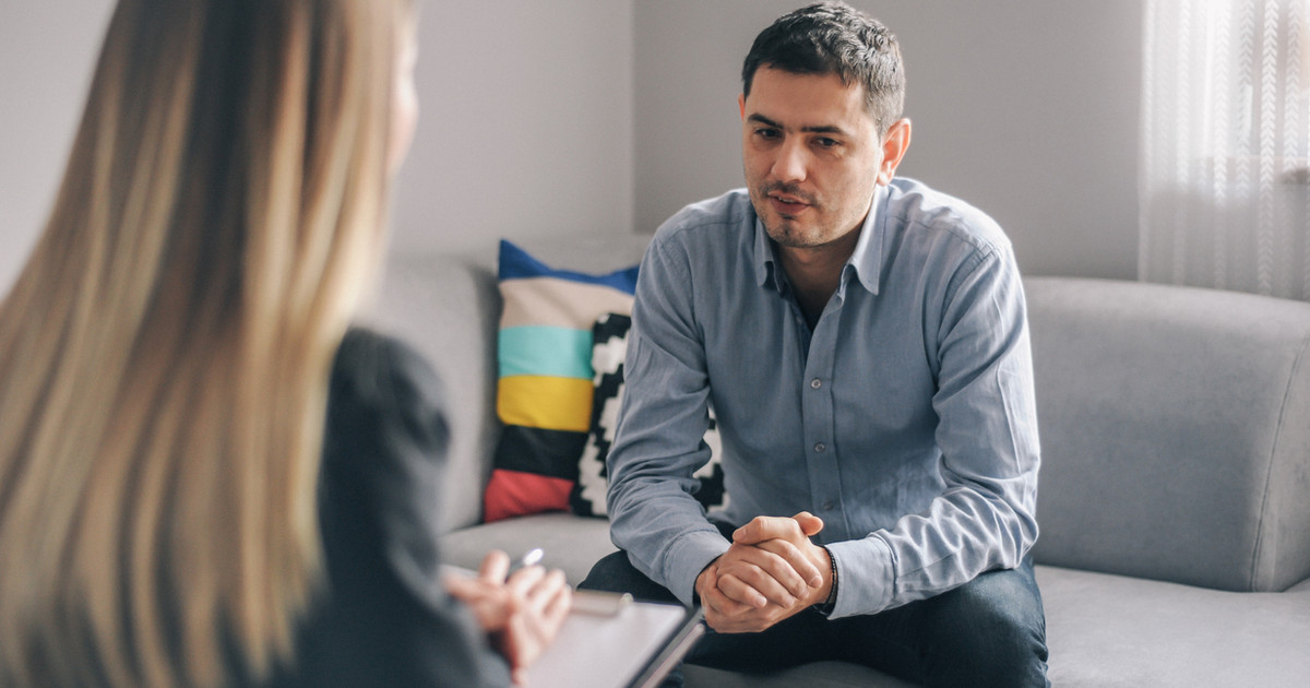A psychologist working with a person to identify unhelpful thinking patterns and develop practical coping strategies for persistent pain.