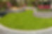 Detail of a professional stone retaining wall bordering a clean grass lawn