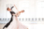 elegantly dressed a boy and a girl dancing on the floor
