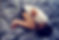 Woman curled on bed