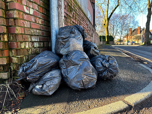 Black bin bags piled up on corner of street