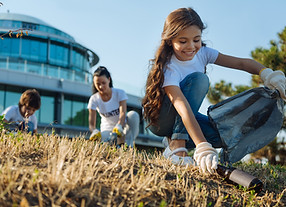 A group of community members work to clean-up a local park as part of a STEM event. 