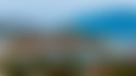 View of a Mediterranean marina with sailboats tied along pontoons