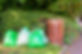 Green rubbish bags next to a brown bin for collection