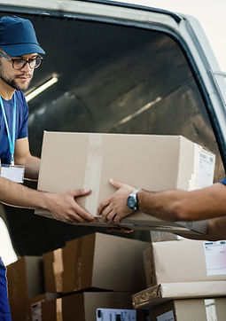 Workers Unloading Packages from Van