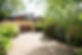 Trees around a house with resin driveway
