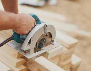 Caucasian construction worker sawing wood planks