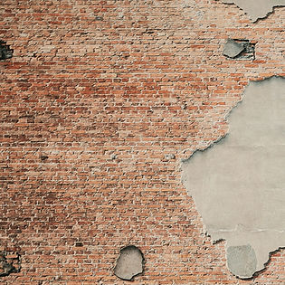 An old red brick wall where a large patch