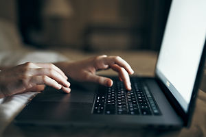 Hands Typing on Laptop Keyboard