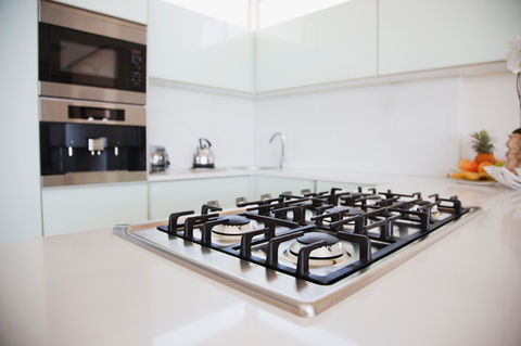 Modern kitchen with a sleek gas stove on a white countertop